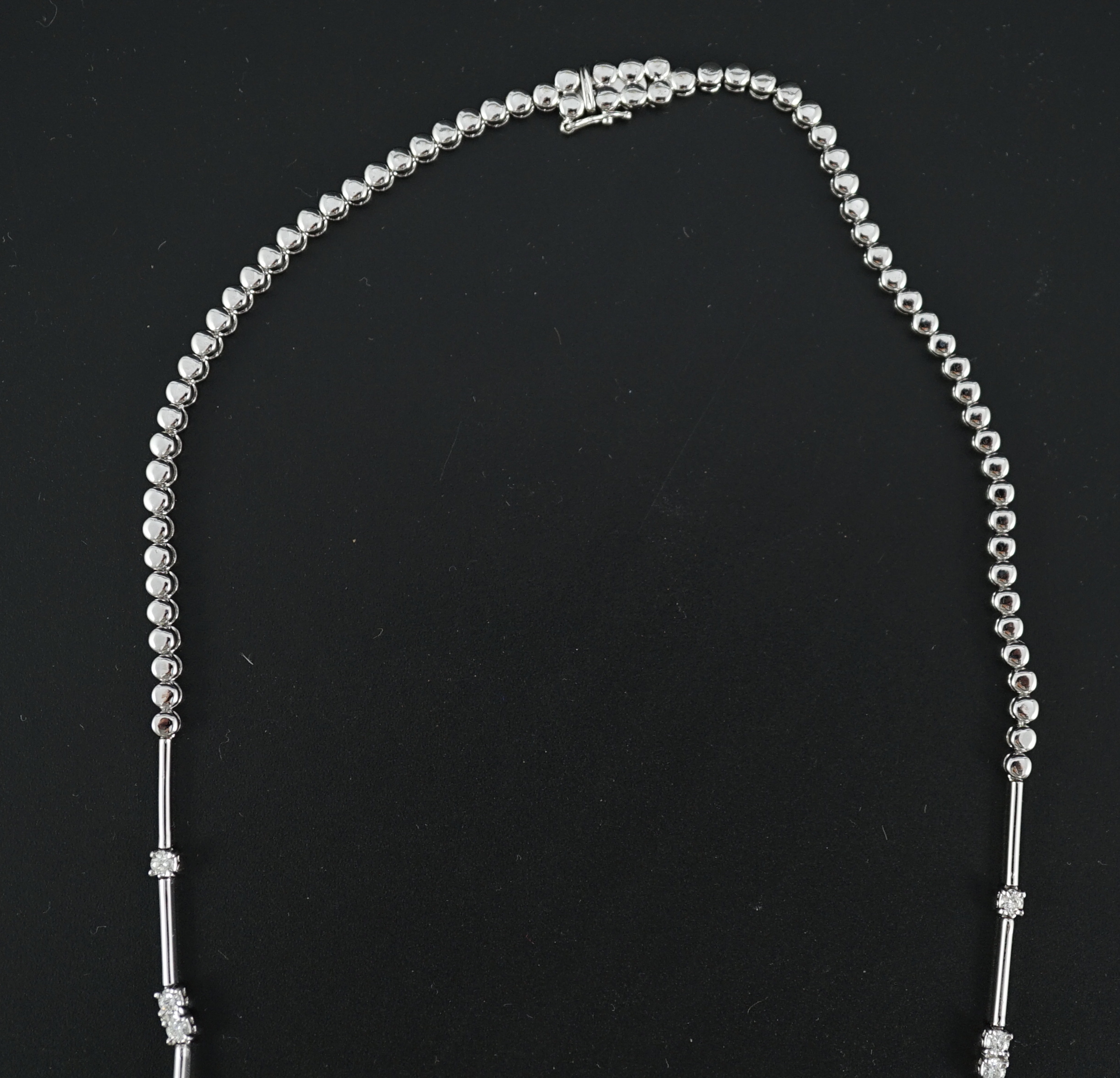 A modern 18k white gold and diamond cluster set necklace